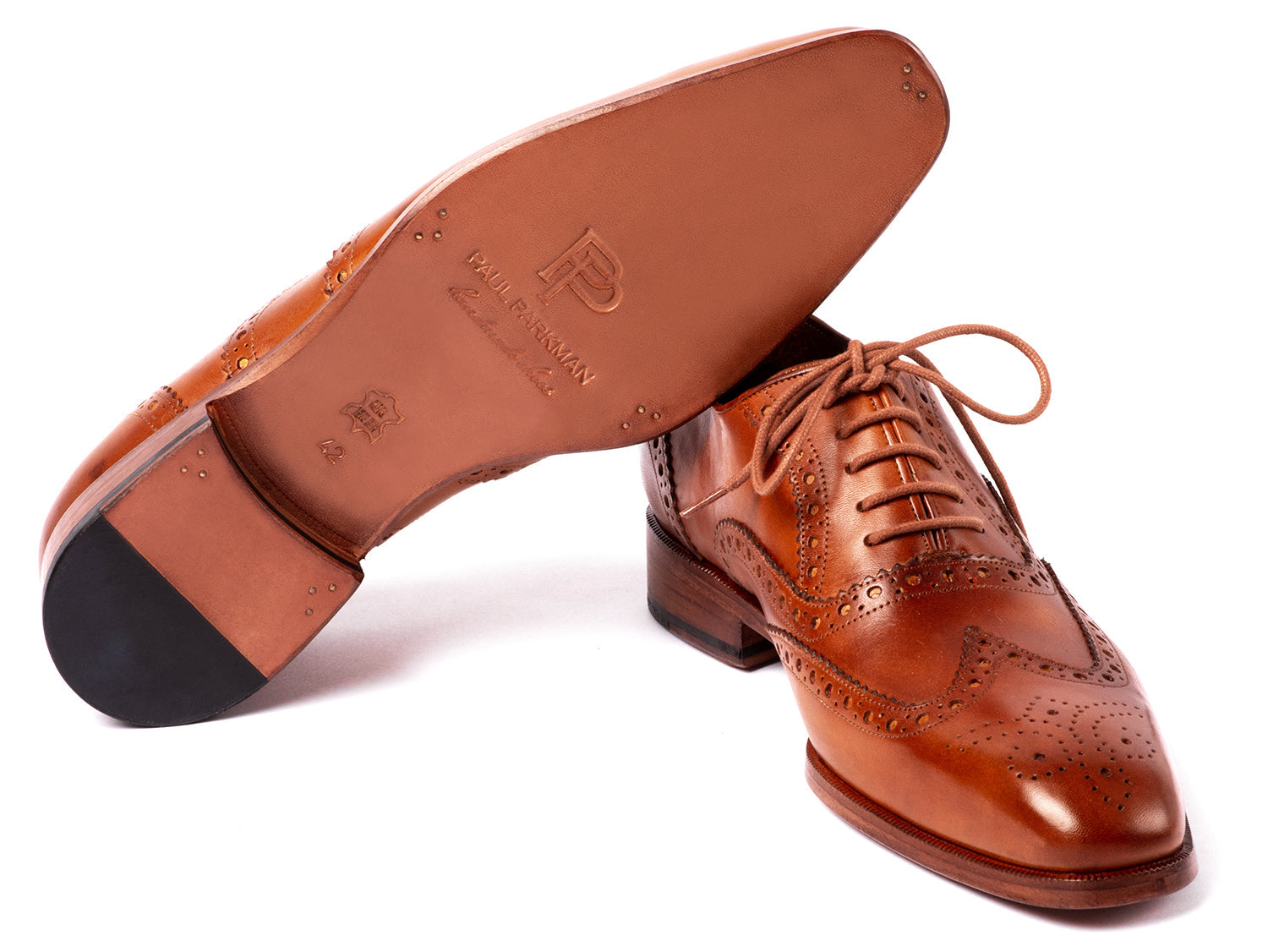 The Paul Parkman Wingtip Oxfords Mid Brown - 5447-BRW are brown hand-painted leather brogues with decorative perforations and laces, displayed against a white background.