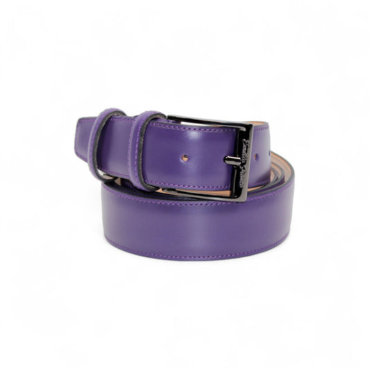 The Matiste Purple Leather Belt 201 by Matiste, crafted from genuine purple leather with a shiny black metal buckle, reflects Italian craftsmanship and is displayed coiled on a white background.