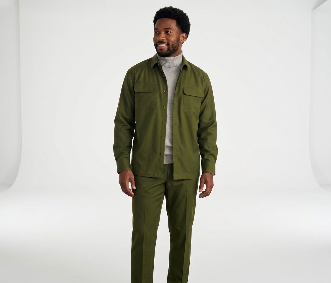 A man is wearing the Inserch Two-Pocket 2pc Set SE004-00020 Chive, featuring a regular fit olive green long sleeve shirt and matching olive green pants from Inserch, styled over a gray turtleneck sweater while standing against a beige background.
