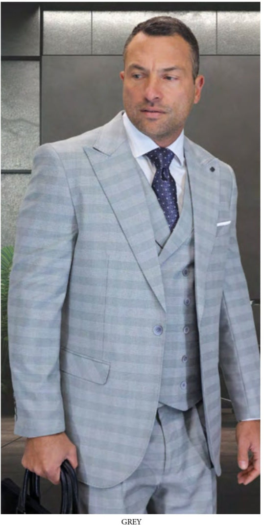 Three men wear Statement Clothing's BALANCIGA-GREY plaid three-piece suits with pleated pants or a double-breasted vest, each in navy, grey, or black, posing in distinct indoor settings.