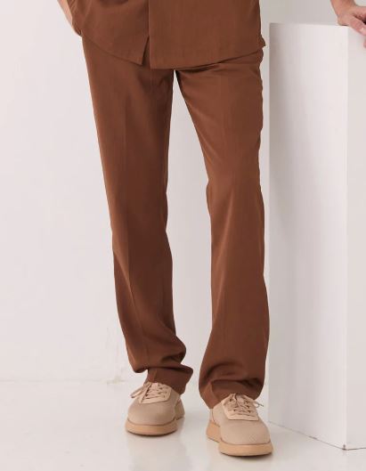 A man wears the Inserch 2pc Set (Shirts and Pants) Mocha by Inserch, featuring a short-sleeve button-up mocha shirt and matching pants, standing against a plain background.