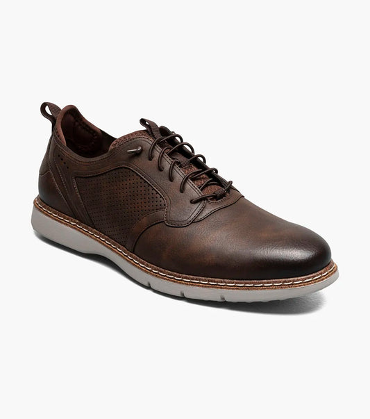 The STACY ADAMS Score Plain Toe Elastic Lace Up in Brown (style 21538-215) is a business-casual leather shoe featuring perforated side panels, a white sole, elastic lace-up front, and detailed stitching with a supportive RedZone footbed—displayed against a plain white background.