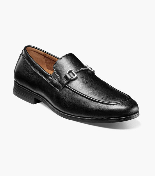 The STACY ADAMS Richmont Moc Toe Bit Slip On in Black Tumbled (21567-007) features black leather, a metal bit detail, low heel, and brown lining—shown here as a stylish dress casual loafer on a white background.