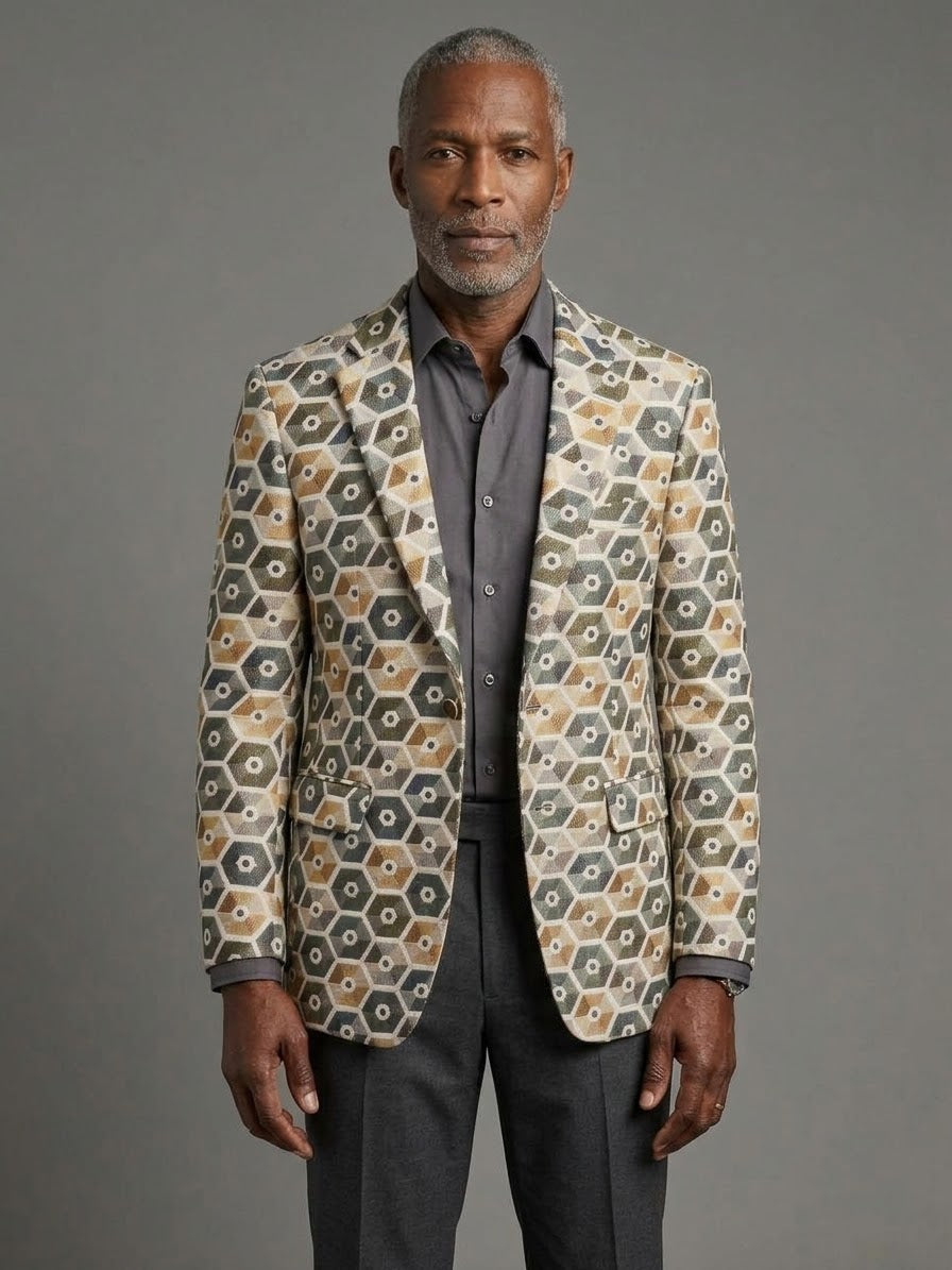 A man faces the camera in EJ SAMUEL’s Jacket 15 Size 34 (Extra Small) and 36 (Small), grey with hexagonal pattern. Plain grey background. Final sale—no returns or exchanges.