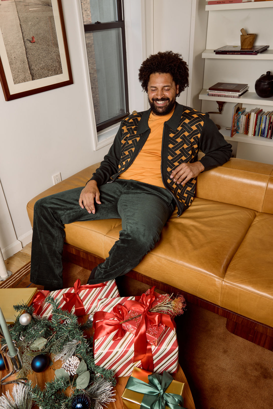 A man wears the Inserch Geometric Full Zip Sweater SW908-00021 in hunter green, featuring a woven geometric pattern on the front, paired with dark corduroy pants and a mustard-colored shirt.