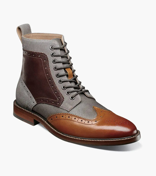The STACY ADAMS Finnegan Wingtip Lace Up Boot in Cognac Multi features brown leather, dark brown and gray fabric panels, decorative perforations, a lace-up front, and a memory foam insole for comfort.