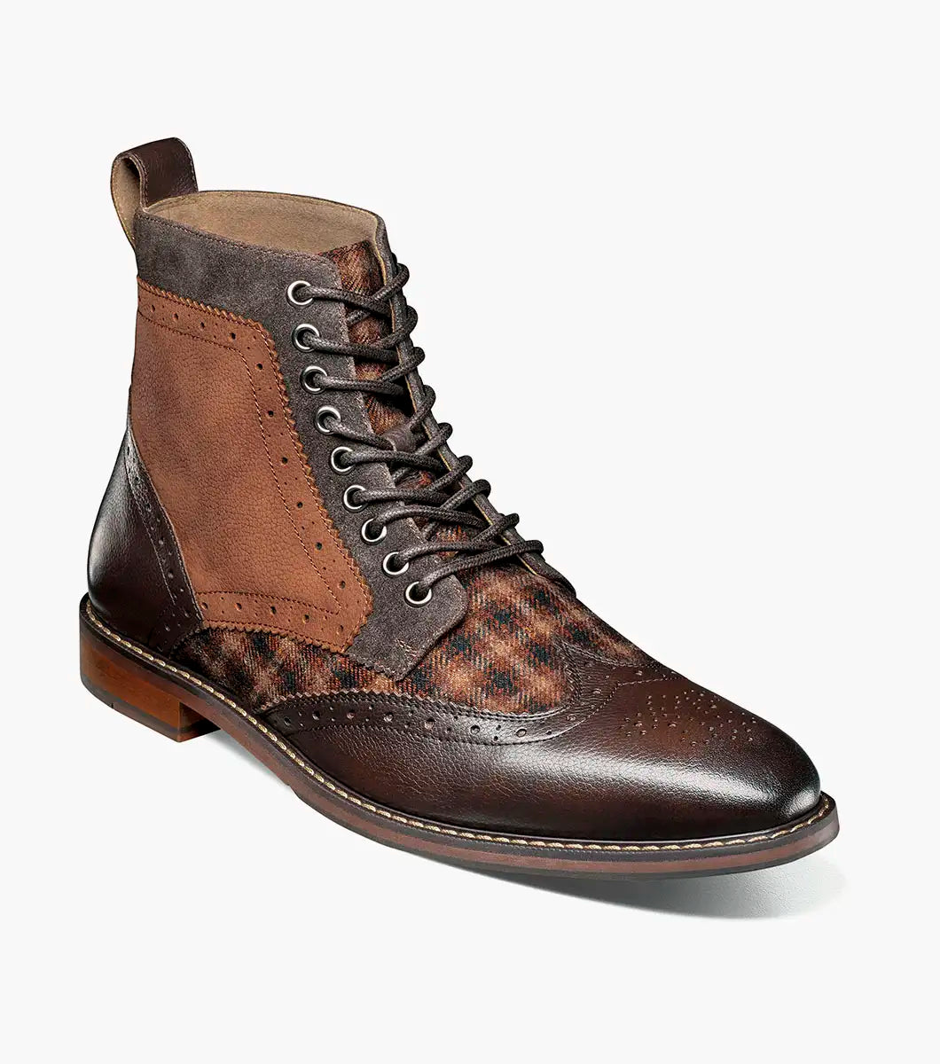 The STACY ADAMS Finnegan Wingtip Lace Up Boot in Brown Multi features leather and suede, perforated details, a patterned fabric panel, low wooden heel, and cushioned memory foam insole for comfort. Style #: 25427-249.