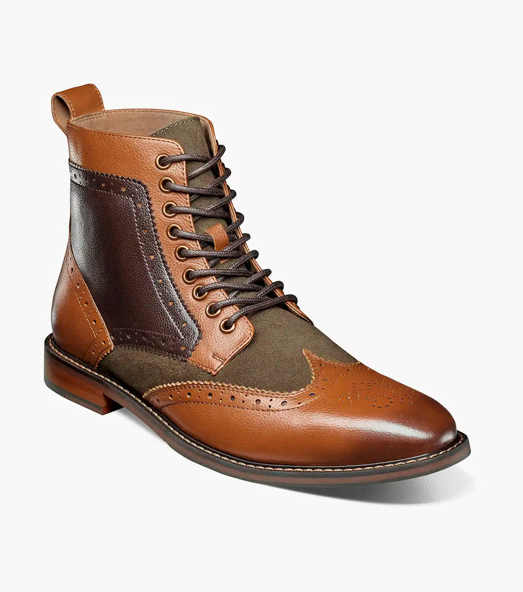 The STACY ADAMS Finnegan Wingtip Lace Up Boot in Olive Multi features brown leather and olive green textile, brogue detailing, a memory foam insole, and a low heel, shown against a white background.