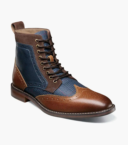 The STACY ADAMS Finnegan Wingtip Lace Up Boot (Cognac with Navy, 25427-470) features two-tone leather, brogue details, and a low heel—ideal for those seeking stylish and comfortable footwear. Shown in left profile on a white background.