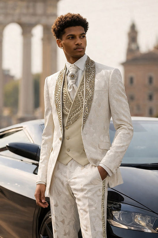Wearing a Manzini TOWER 3-Piece Slim-Fit Vintage Tuxedo Prom Wedding Suit with rhinestones in tan, a man stands before a black car with historic architecture in the background.