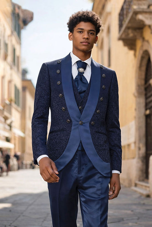 A man in a Manzini MIDLAND 3-piece slim-fit vintage tuxedo with satin trim in Midnight stands on a sunlit European street.