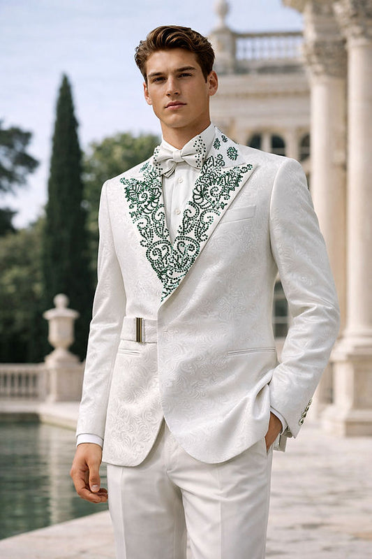 A man in a Manzini MANZINI MZS-606 Men's Double Breast Slim-Fit Coat, featuring a shiny rhinestone floral pattern in white and green, stands outside near a classical building and pool.