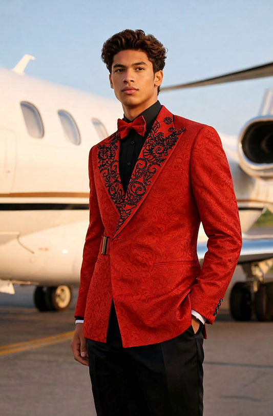 A man in a Manzini MANZINI MZS-606 Double Breast Slim-Fit Coat with shiny rhinestone red and black floral pattern stands in front of a private jet on an airport tarmac.