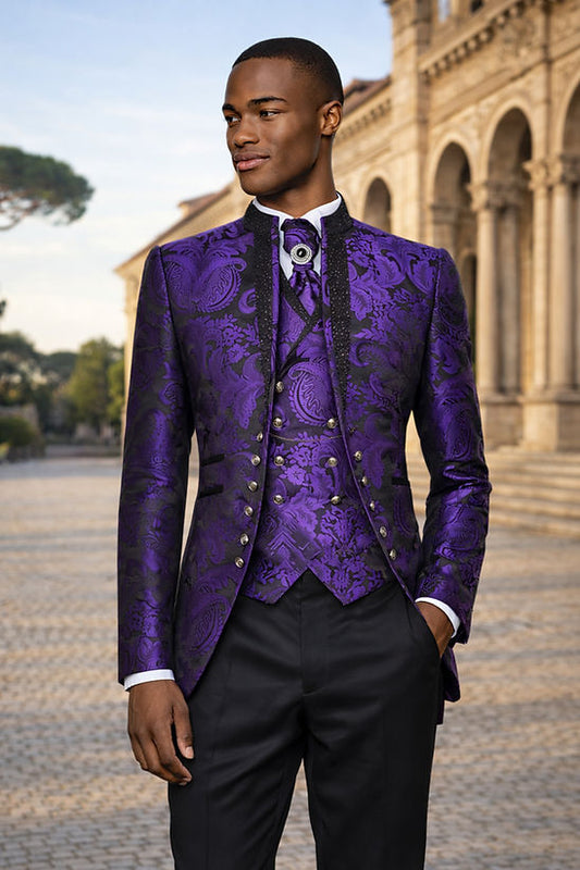 A man wears the Manzini Lanzini 3-Piece Slim-Fit Baroque Gothic Tuxedo with rhinestones in purple by Manzini, posing outside a historic stone building.