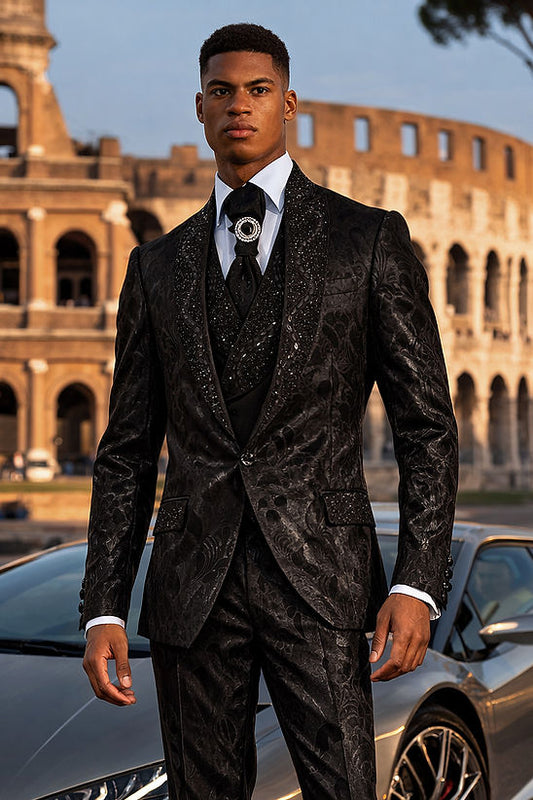 A man in a Manzini TOWER 3-Piece Slim-Fit Vintage Tuxedo Prom Wedding Suit with rhinestones in black-black stands before a sports car and the Colosseum in Rome, Italy.