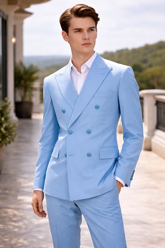 A man in a Manzini IMPRESS Men's 2PC Spandex Double Breast Slim-Fit Suit in Sky and a white shirt stands on an outdoor terrace with greenery and hills behind him.