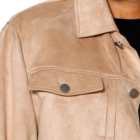 A man in the INSOMNIA ROMEO 2PC Khaki Vegan Suede Leisure Suit by Insomnia stands before a light-textured wall, looking slightly right.