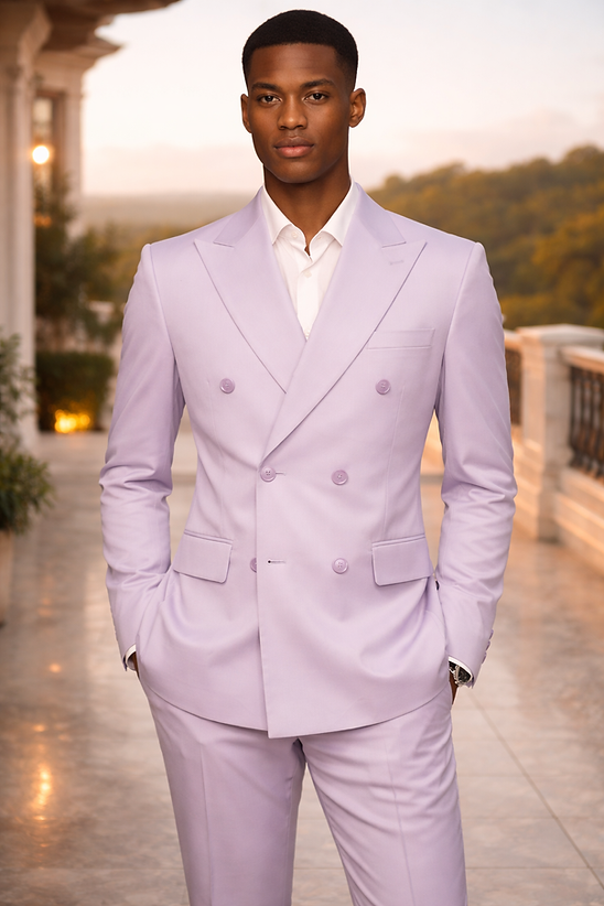 A man stands on a balcony wearing the Manzini Impress Men's 2PC Spandex Double Breast Slim-Fit Suit in lavender with a white shirt, hands in pockets, and trees visible in the background.
