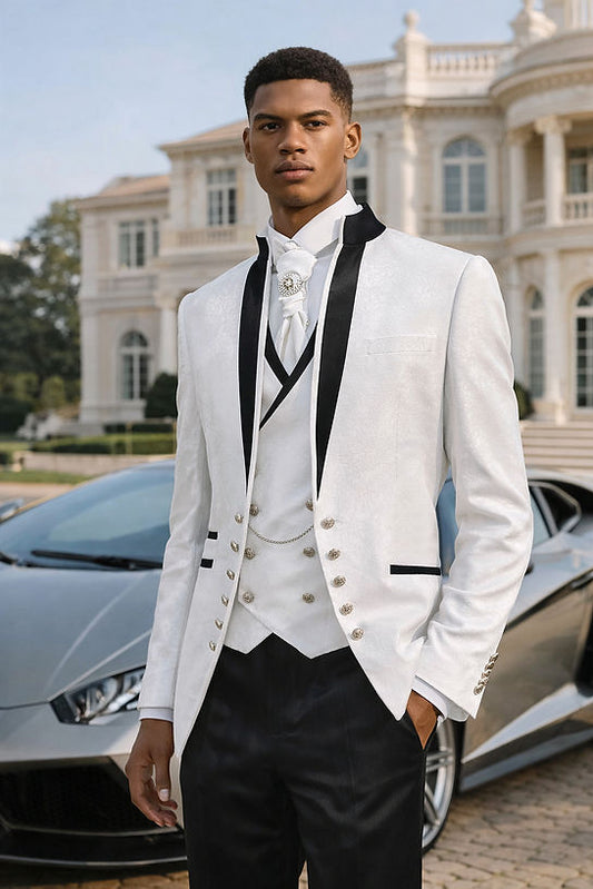 A man in a Manzini MANZINI OAK 3-Piece Slim-Fit Baroque Gothic Tuxedo Prom Wedding Suit with satin trim in white stands before a luxury car and elegant mansion, looking directly at the camera.