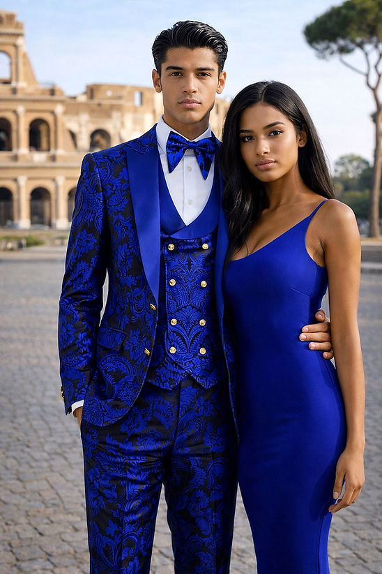 A man in a Manzini Armani 3-Piece Slim-Fit Men's Satin Paisley Pattern Tuxedo Prom Royal stands outdoors with a woman in a blue dress, against historic stone architecture.