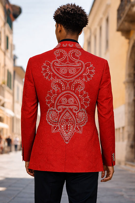 A man stands outdoors on a sunlit street, wearing the MANZINI MZS-607 Men's Double Breast Slim-Fit Coat in shiny red with rhinestone floral pattern by Manzini, paired with a bow tie, black shirt, and black pants.