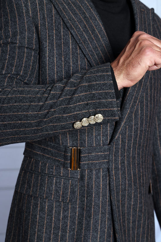 A man wearing the Manzini MANZINI MZW-702 Men's Pinstripe Blazer Coat w/ Hook Belt in charcoal over a black turtleneck, shown from the shoulders up against a light background.