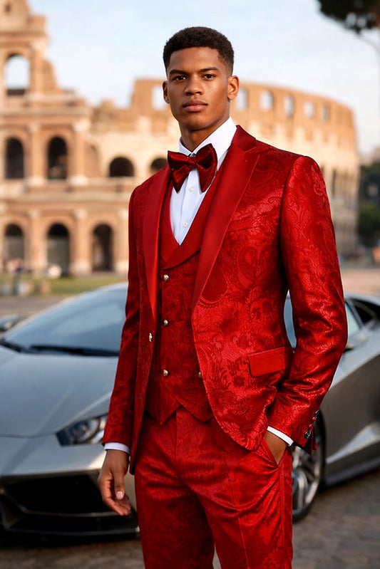 A man in a Manzini Armani 3-Piece Slim-Fit Men's Satin Paisley Pattern Tuxedo Prom Red stands in front of a silver sports car and the Colosseum in Rome.