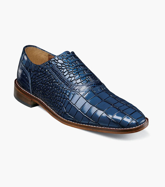 The Stacy Adams Riccardi Plain Toe Oxford (25575-400) is a single blue shoe with croco and lizard print leather, brown sole, closed lacing, and anatomical arch support, displayed on a white background.