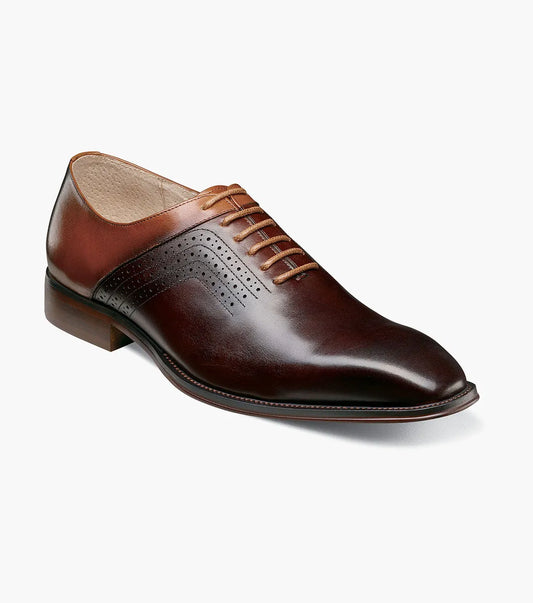 The Stacy Adams Halloway Plain Toe Oxford in Brown Multi features perforated detailing, closed lacing, a low wooden heel, and a cushioned Memory Foam insole. Shown on a plain white background.