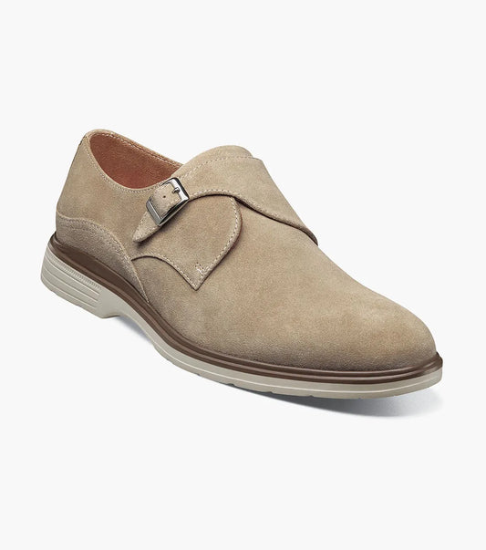 The Stacy Adams Taylen Plain Toe Monk Strap in Sandstone features beige suede leather, a single side buckle, anatomical arch support, low heel, and a textured rubber sole. Displayed on a white background.