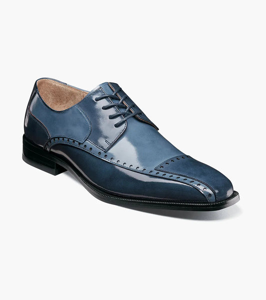 The Stacy Adams Plaza Modified Cap Toe Oxford in Blue Multi (25608-460) features decorative stitching, laces, a cushioned insole, and a low black heel, shown as a single shoe on a white background.
