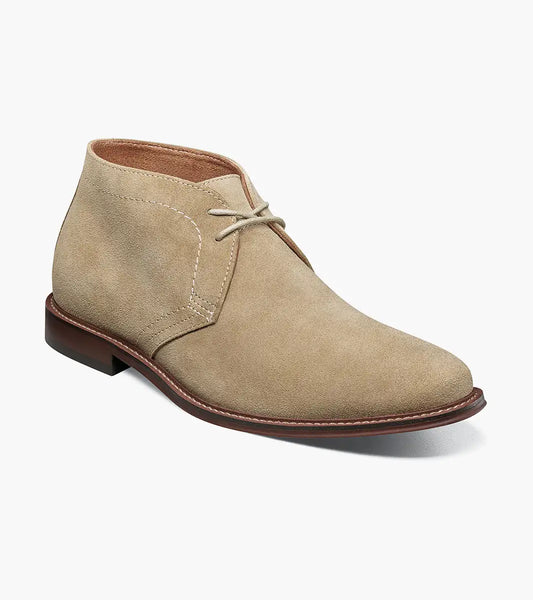The Stacy Adams Martfield Plain Toe Chukka Boot in Sand features a tan suede upper, two eyelets, light brown laces, visible stitching, and a brown rubber sole.