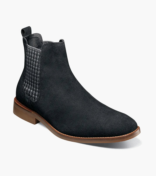The Stacy Adams Gabriel Plain Toe Chelsea Boot (25625-008) features a black suede upper, brown sole, houndstooth side panel, elastic gusset, and rear pull tab.
