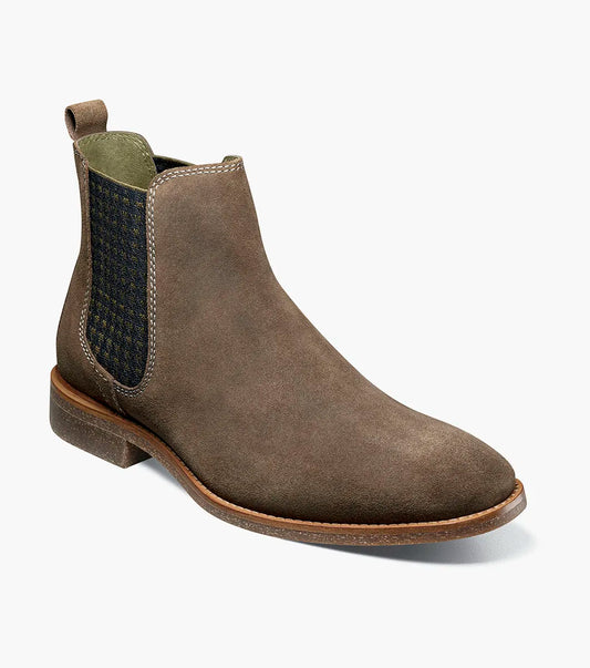 The STACY ADAMS Gabriel Plain Toe Chelsea Boot in Mushroom (25625-051) features a brown suede upper, side elastic panel, back pull tab, low heel, and cushioned RedZone footbed, displayed on a plain white background.