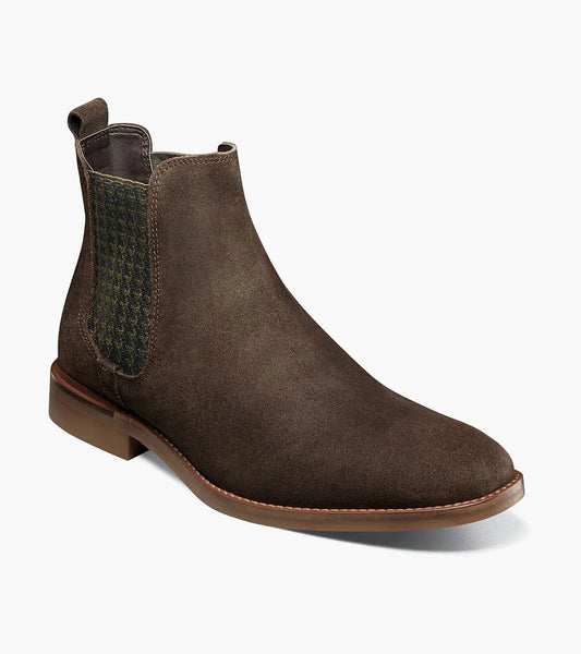 The Stacy Adams Gabriel Plain Toe Chelsea Boot in brown suede (25625-245) features a low heel, elastic side panel, RedZone footbed for comfort, and a back pull tab. Shown on a plain white background.