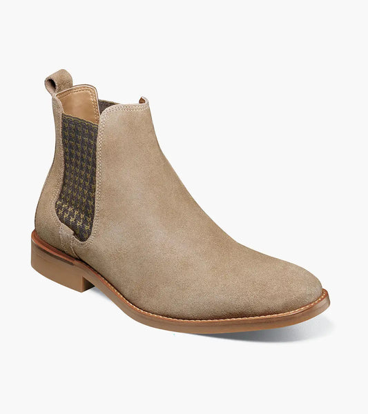 The Stacy Adams Gabriel Plain Toe Chelsea Boot in Sand features tan suede leather, a brown sole, houndstooth-patterned elastic side panel, RedZone footbed for comfort, and a back pull tab.