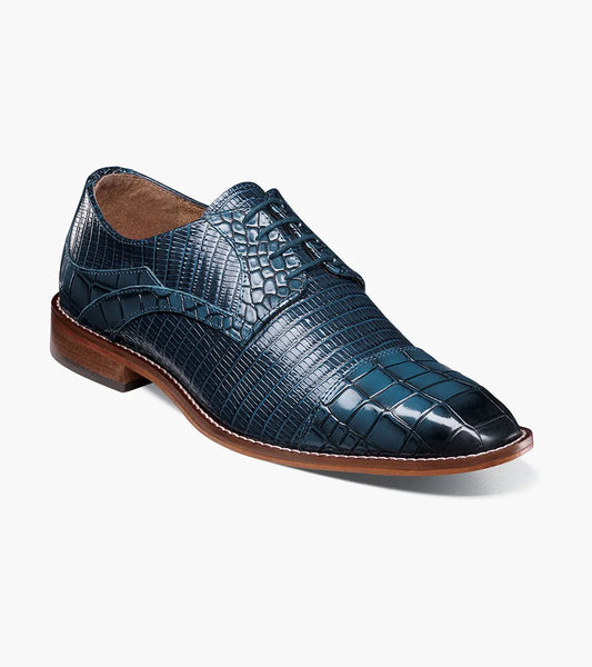 The Stacy Adams Tedesco Cap Toe Oxford (25630-400) is a blue crocodile print leather dress shoe with a RedZone footbed, brown sole, and laces shown on a white background.