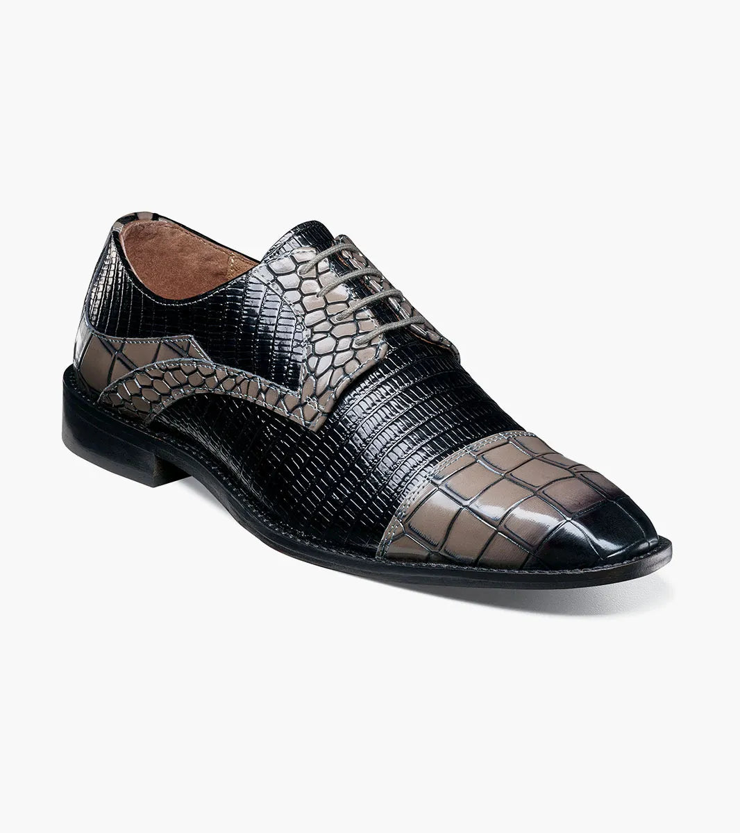 The STACY ADAMS Tedesco Cap Toe Oxford (25630-975) is a black and gray men’s dress shoe with a textured crocodile print leather and a pointed toe, offering refined sophistication.