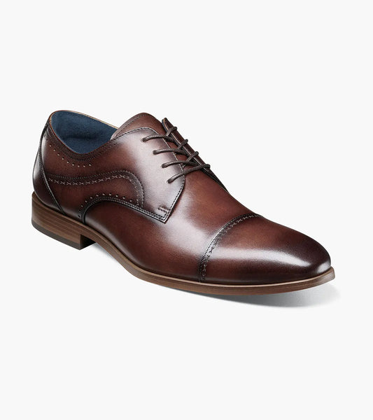 The STACY ADAMS Bryant Cap Toe Oxford (Brown, 25634-200) features burnished leather, decorative stitching, and laces, displayed on a white background.