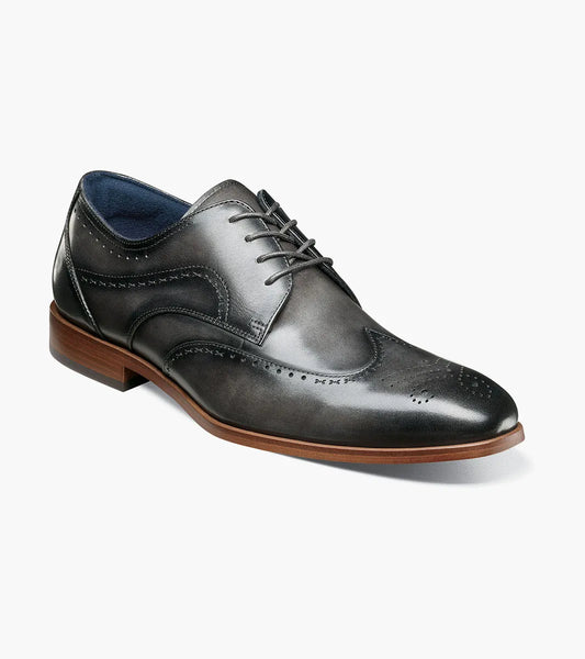 The STACY ADAMS Brayden Wingtip Oxford in gray (25635-020) features brogue detailing, a lace-up closure, and a brown sole, shown individually on a white background.