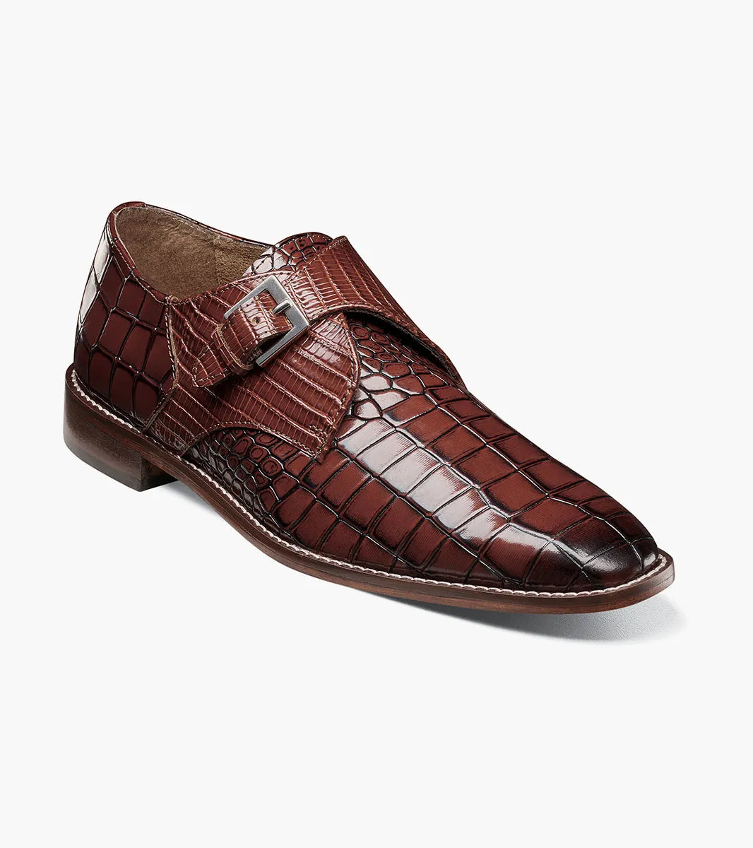 The STACY ADAMS Rapino Plain Toe Monk Strap in cognac (25637-221) features a brown crocodile print leather, side buckle closure, and low heel, shown on a white background.