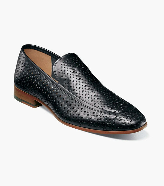 The STACY ADAMS Winden Moc Toe Perf Slip On (Black, 25645-001) features a perforated leather design, memory foam insole for comfort, low heel, and brown sole, shown on a white background.