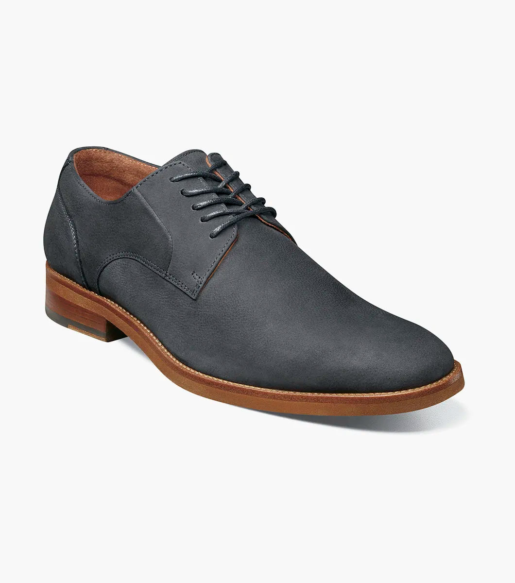 The Stacy Adams Preston Plain Toe Lace Up (Navy, 25650-410) is a single navy leather shoe with a brown sole and black laces, featuring a plain toe lace up design, shown against a white background.
