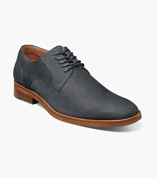 The Stacy Adams Preston Plain Toe Lace Up (Navy, 25650-410) is a single navy leather shoe with a brown sole and black laces, featuring a plain toe lace up design, shown against a white background.