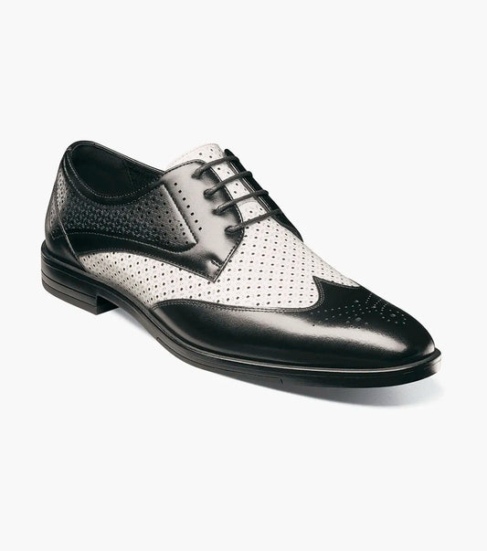 The Stacy Adams Asher Wingtip Lace Up (25653-111) by STACY ADAMS features a black and white leather upper with perforated detailing, lace-up closure, and a low heel, shown on a white background.