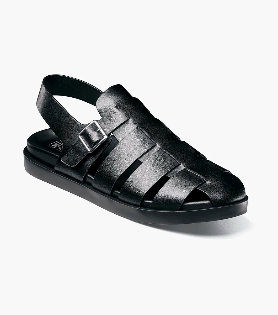 A black STACY ADAMS Montego Slingback Buckle Sandal (25659-001) with a closed toe, cushioned EVA midsole, and buckle strap is shown in profile against a white background.