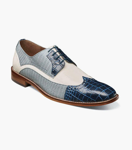 The Stacy Adams Gallinari Wingtip Lace Up in Dark Blue Multi features crocodile-patterned blue, gray, and white leather, brown sole and laces, plus a cushioned footbed for comfort.