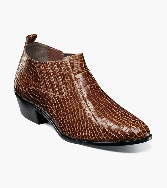 The Stacy Adams Sandoval Cuban Heeled Boot in Cognac (25666-221) features a brown crocodile-print leather, low Cuban heel, and pointed toe, shown on a plain white background.