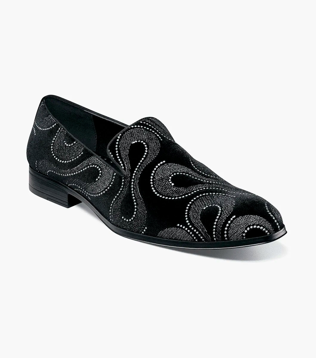 The Stacy Adams Swainson Plain Toe Embroidered Slip On (Black and Silver, 25669-042) features black suede, swirling silver and black embroidery, a low heel, and a memory foam insole for effortless style and comfort.