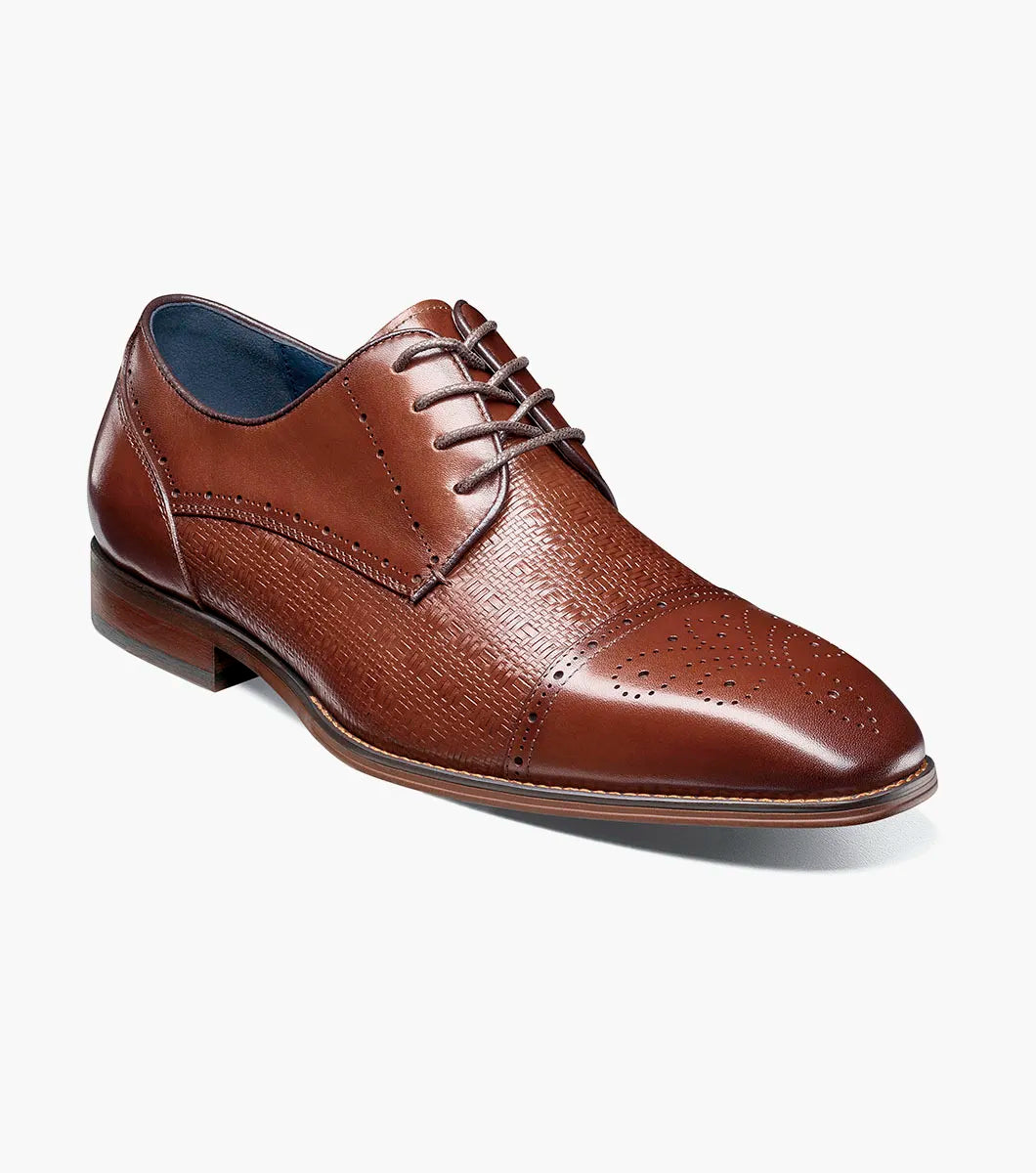 The Stacy Adams Silsbury Cap Toe Oxford in Cognac features decorative toe perforations, textured upper detailing, lace-up closure, low heel, and a memory foam footbed for comfort.